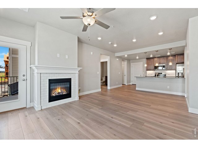 Property Photo 3 Living Room with Gas Fireplace. Finishes may vary. 