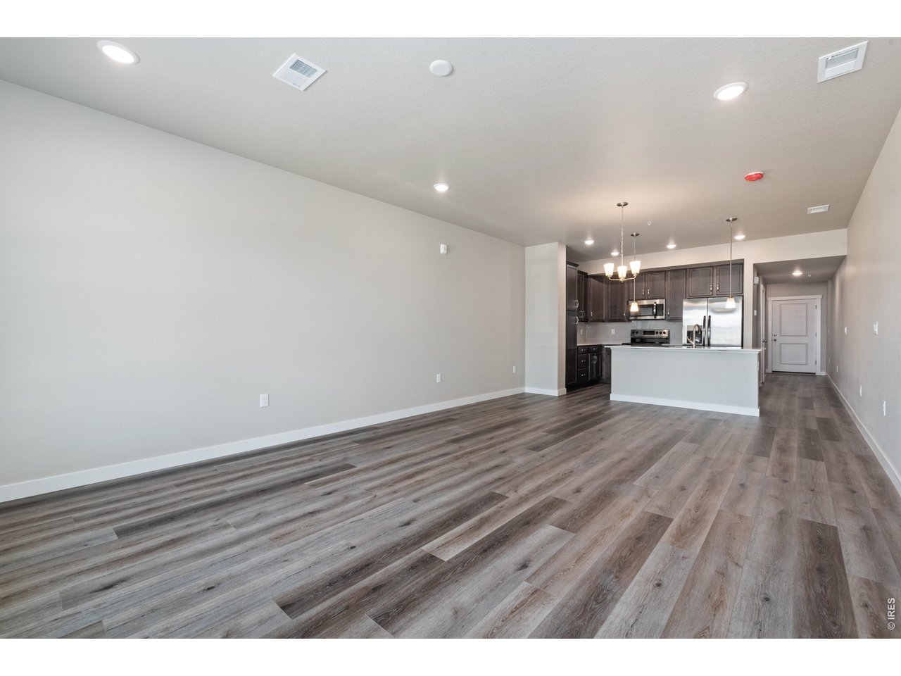 Property Photo 19 Kitchen and Great Room - Finishes may vary. Not actual unit. 