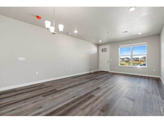 Property Photo 20 Great Room - Finishes may vary. Not actual unit. 