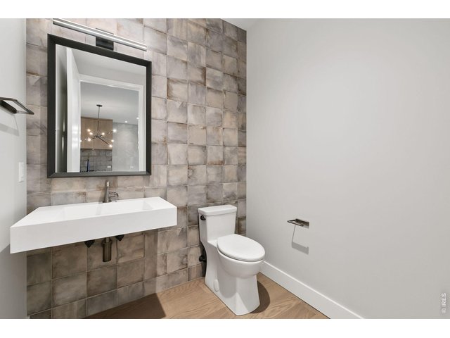 Property Photo 8 Half bath with tile wall and modern floating sink