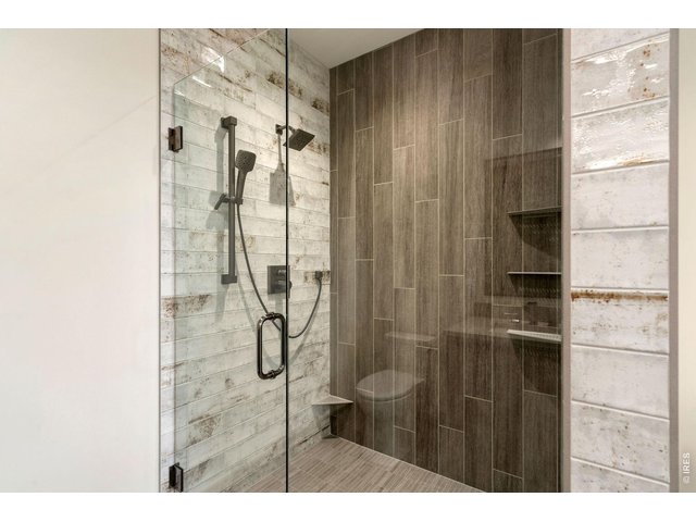 Property Photo 19 Ceiling to floor tile shower in primary bathroom