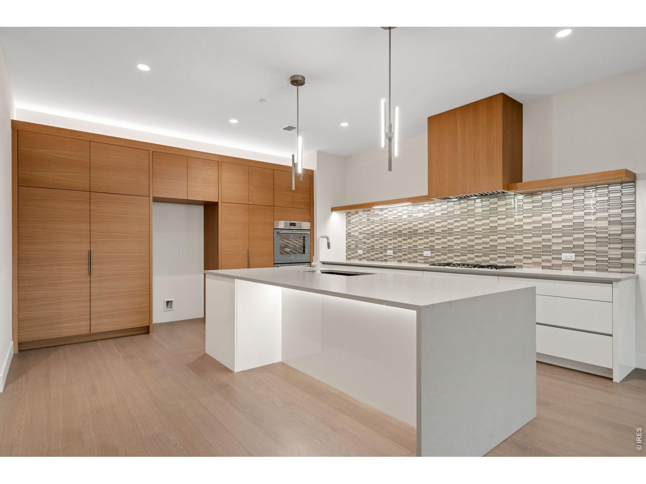 Designer European cabinets, waterfall edge quartz kitchen island, Thermador stainless appliances, no stone was left unturned 