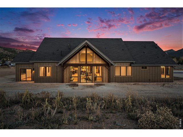Property Photo 2 Back of home - Ample windows and two sliding glass doors to patio
