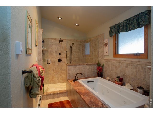 Property Photo 15 Primary suite offers a jetted tub and large walk-in shower