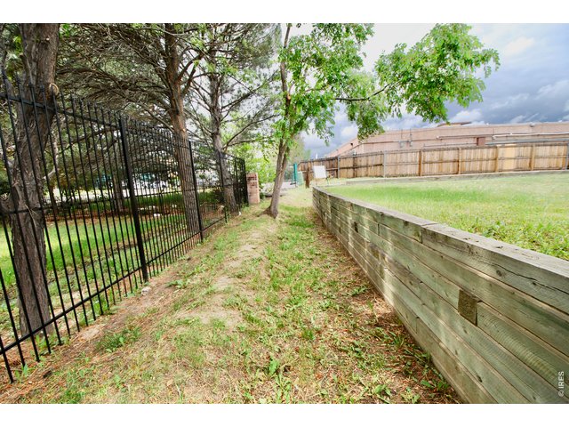 Property Photo 22 South Lot Line has Iron Fence to a Storage Facility