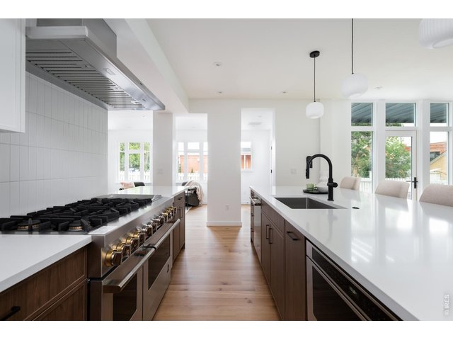 Property Photo 9 Top-of-the-line appliance suite with designer pendant lighting. 