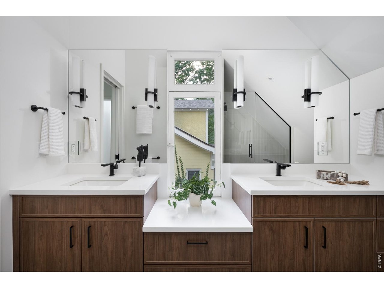 Custom double vanities in the primary suite with abundant storage. 