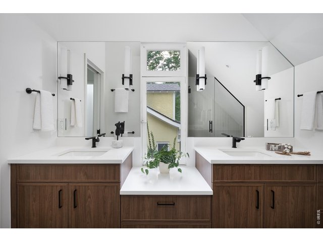 Property Photo 27 Custom double vanities in the primary suite with abundant storage. 