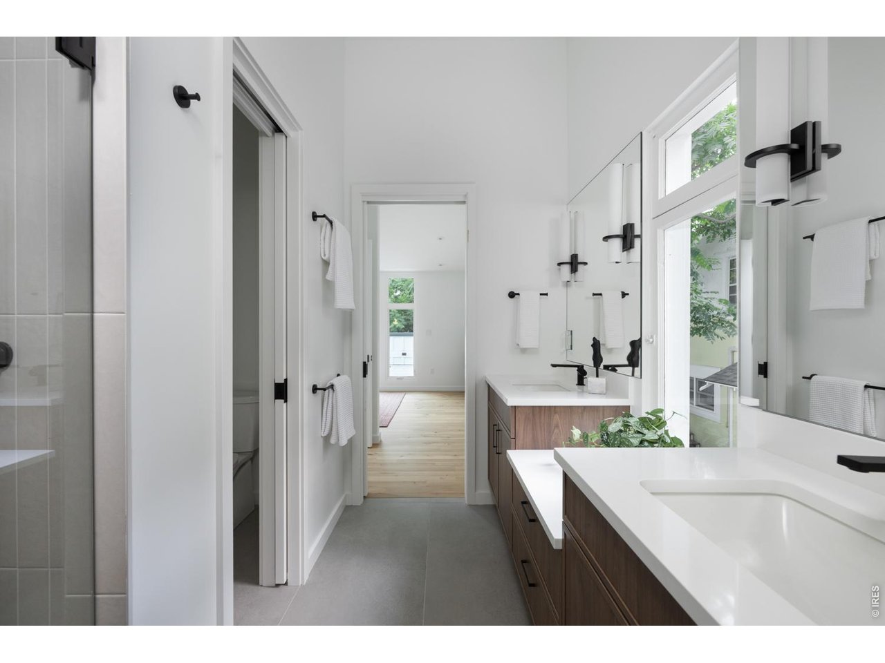 Private water closet and glass walk-in shower for primary suite. 