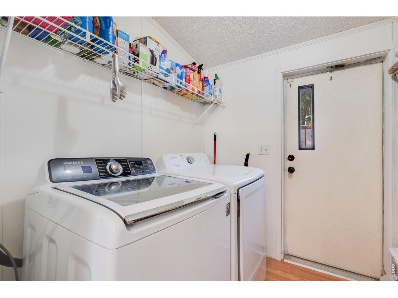 Laundry area and door leading to the backyard. 