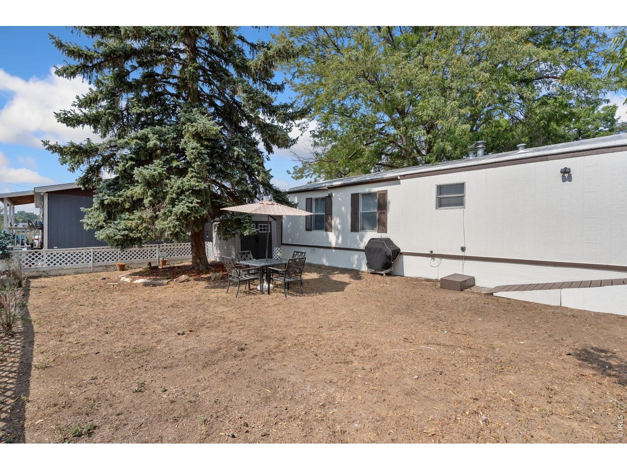 Large fenced in front yard perfect for entertaining and gardening. 