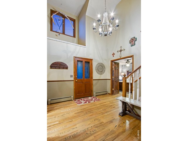 Property Photo 24 Spacious Foyer with vaulted ceilings and decorative art niche and beautiful chandelier 