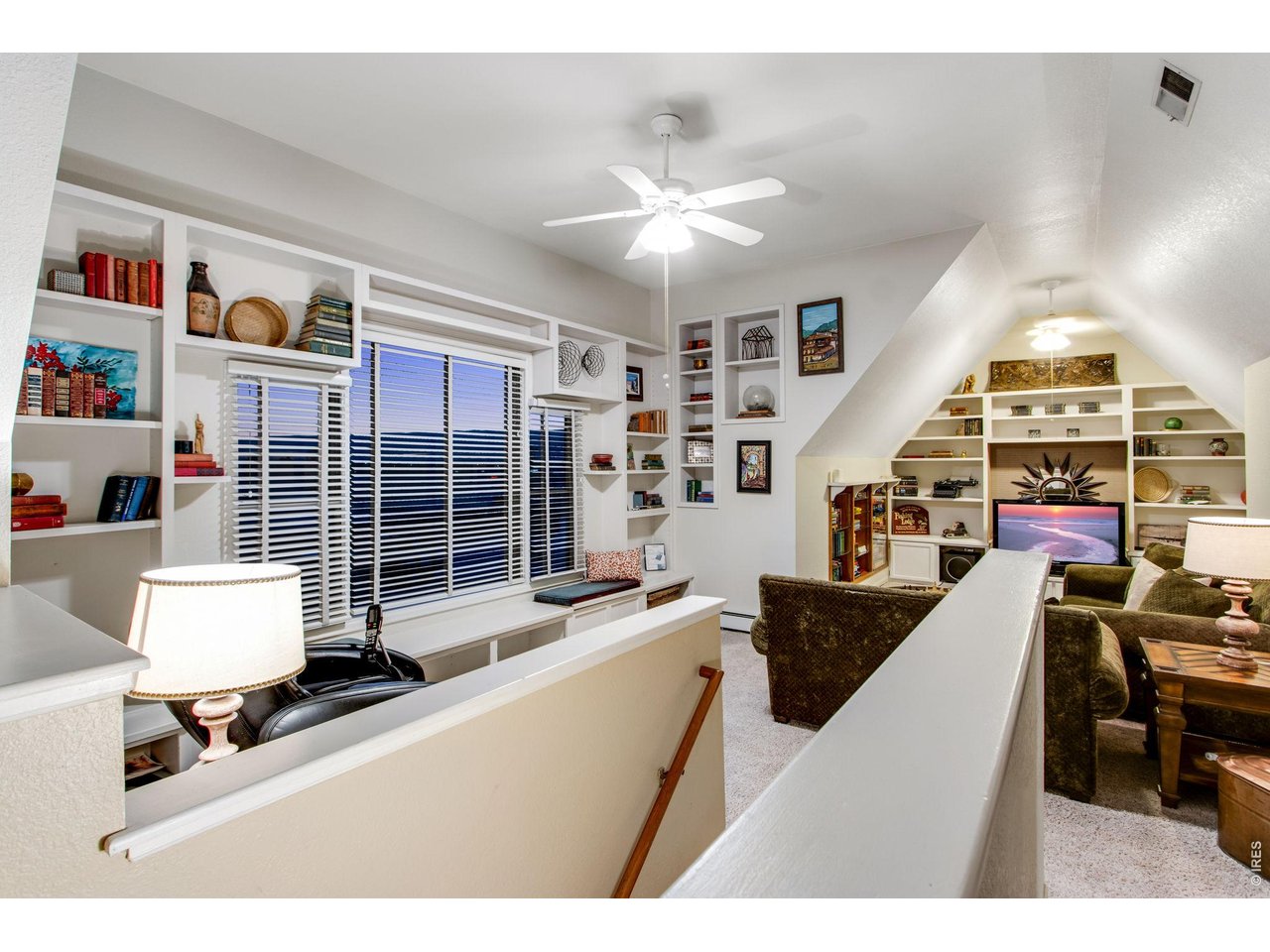 Upstairs family room/loft with sitting bench along window with added storage 