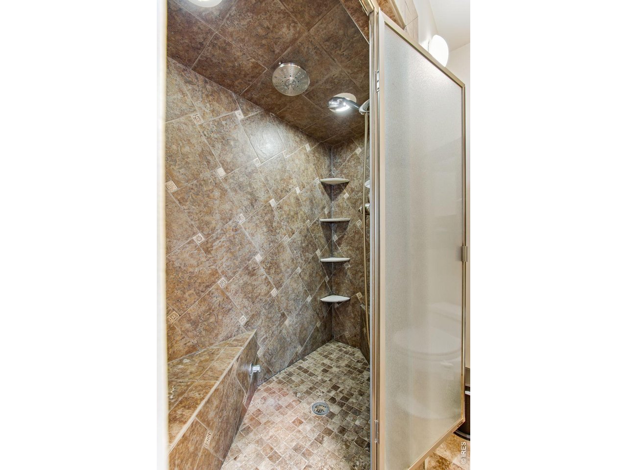 Large bathroom with floor-to-ceiling tile shower 