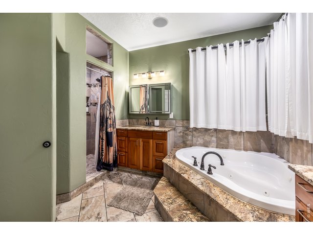 Property Photo 10 Jetted soaking bathtub & two separate vanity areas