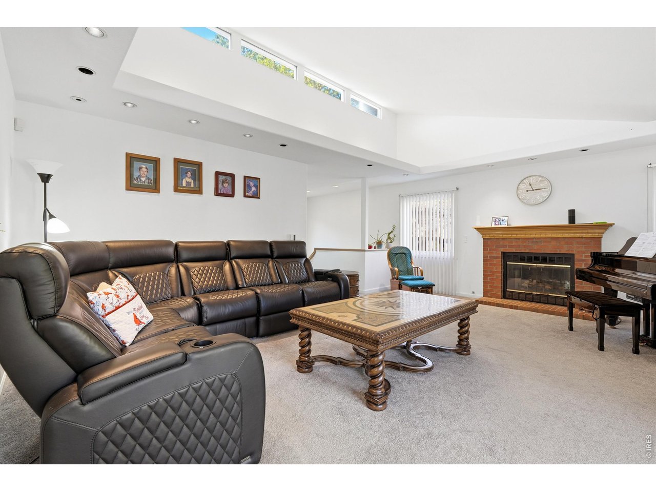 The great room with vaulted ceilings has another fireplace to enjoy. 