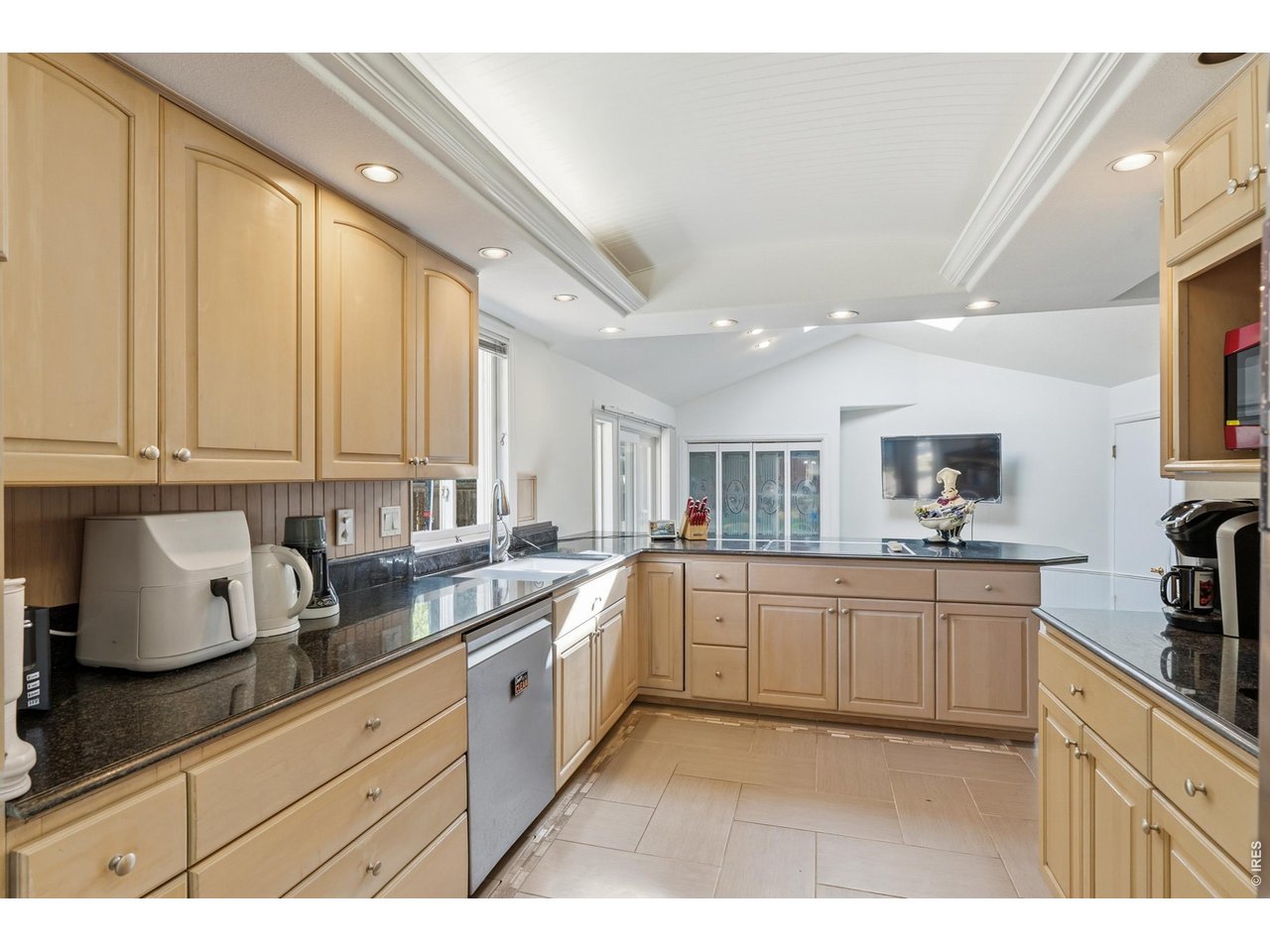 Intricate wood detail on the ceiling with plenty of lights is a statement piece for the kitchen. 