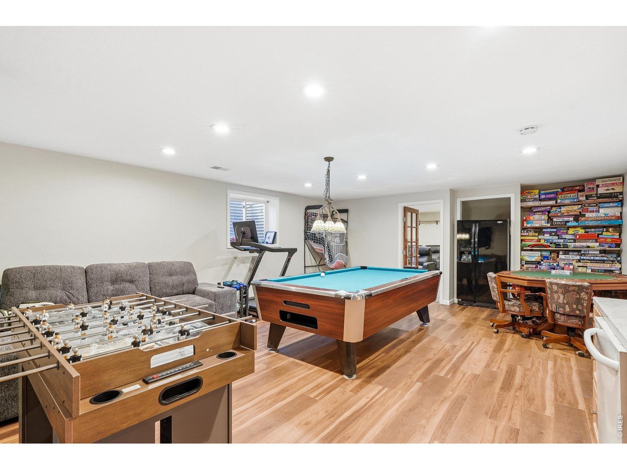 Fully renovated basement with new luxury vinyl flooring, new paint, and wet bar. 