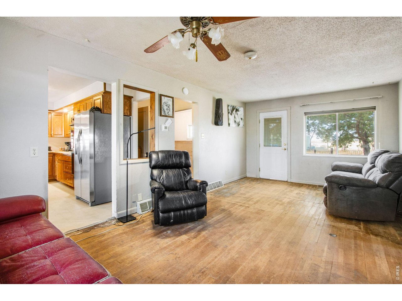 Living room, front door and window face west. kitchen to the left