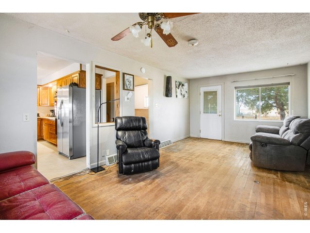 Property Photo 16 Living room, front door and window face west. kitchen to the left