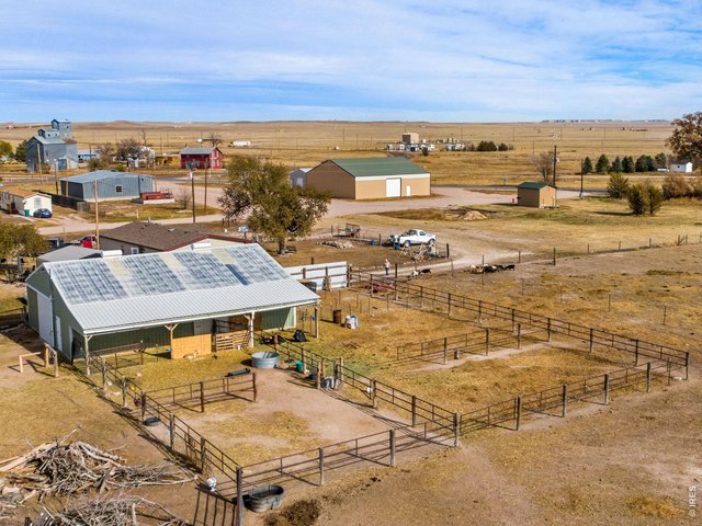 Property Photo 2 36'x48' Barn also has wide door under 10' deep overhang and 4 pens with central watering tank.