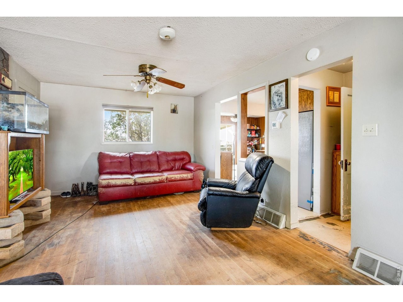From the front entry, 21'x12' living room with back window facing east. Kitchen is to the right.