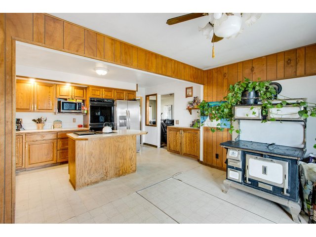Property Photo 22 Notice basement entry in floor in front of antique wood stove