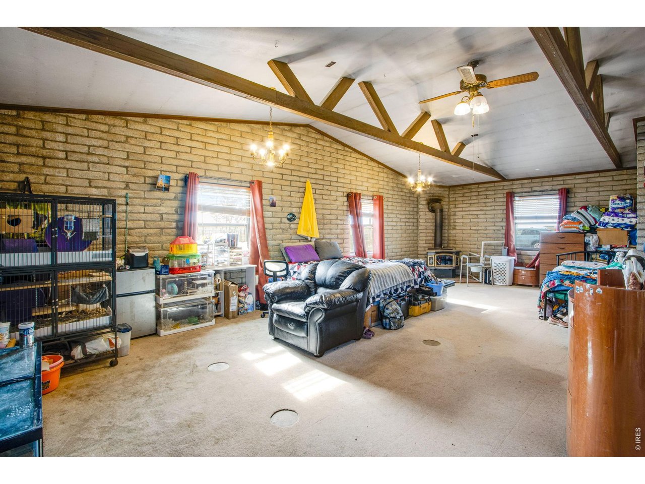 Large 31x21 family room has 3/4 bath in back corner. Windows facing south and west. Note wood stove in far corner