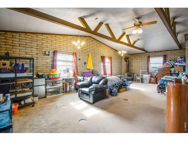 Property Photo 30 Large 31x21 family room has 3/4 bath in back corner. Windows facing south and west. Note wood stove in far corner