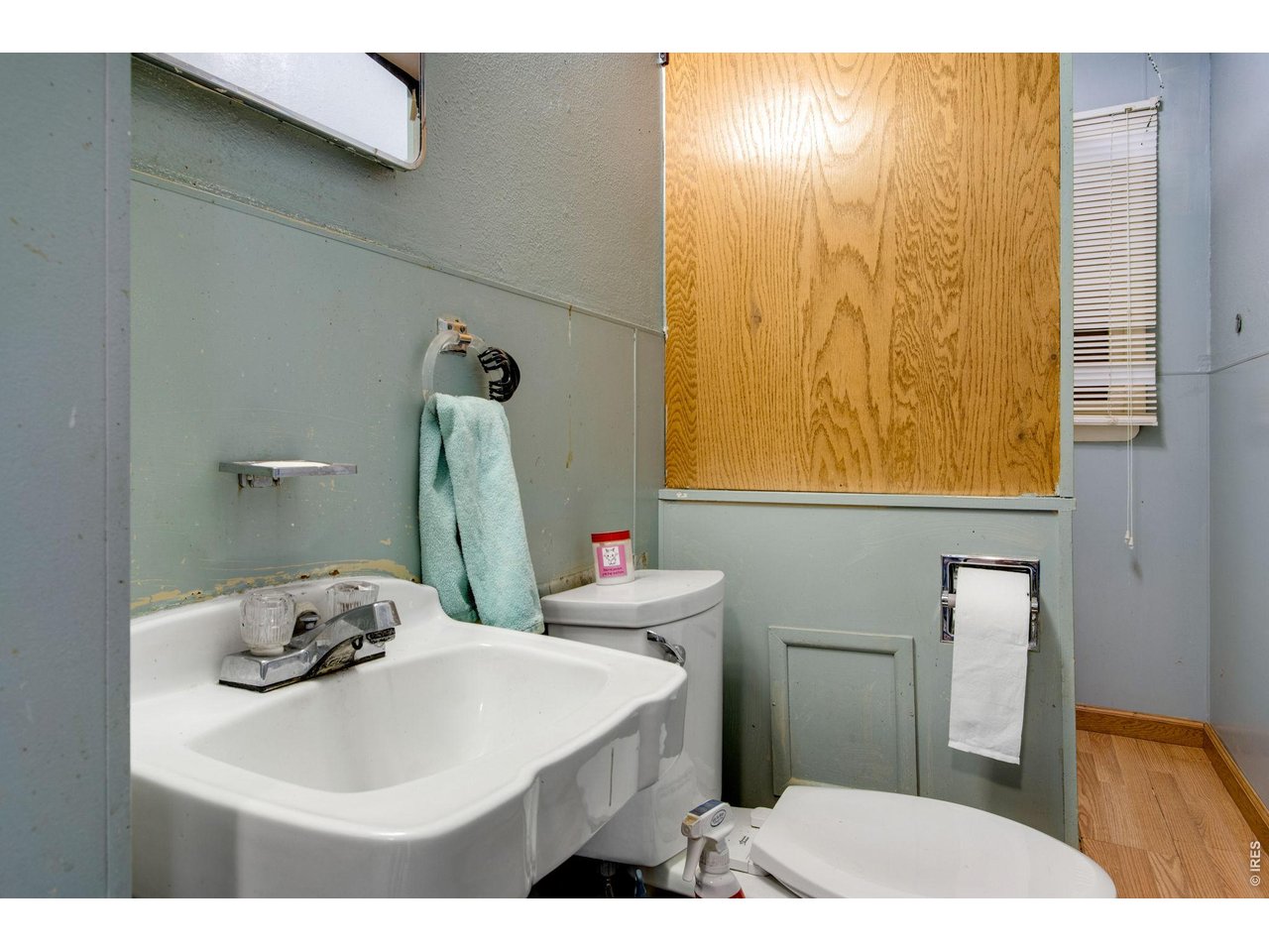 Full hall bathroom with full tub with shower in rear.
