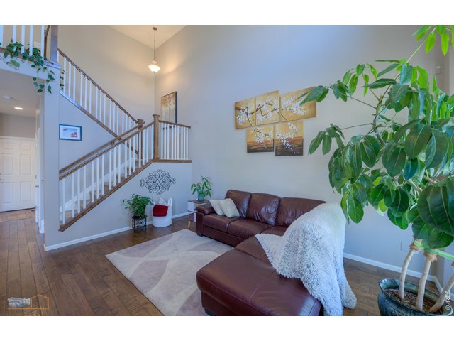Property Photo 8 Two Story Living Room And Open Stairway With Wooden Handrail