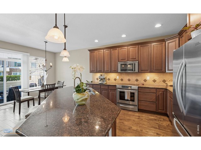 Property Photo 12 Kitchen Features Stainless Steel Appliances. KitchenAid Double Door Fridge, KitchenAid Electric Range/Oven, KitchenAid Dishwasher, Electrolux Microwave. SS Double Basin Sink