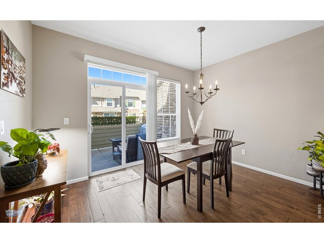 Property Photo 13 Dining Room Features Wood Floors And Sliding Glass Door With Access To A Large Private Patio