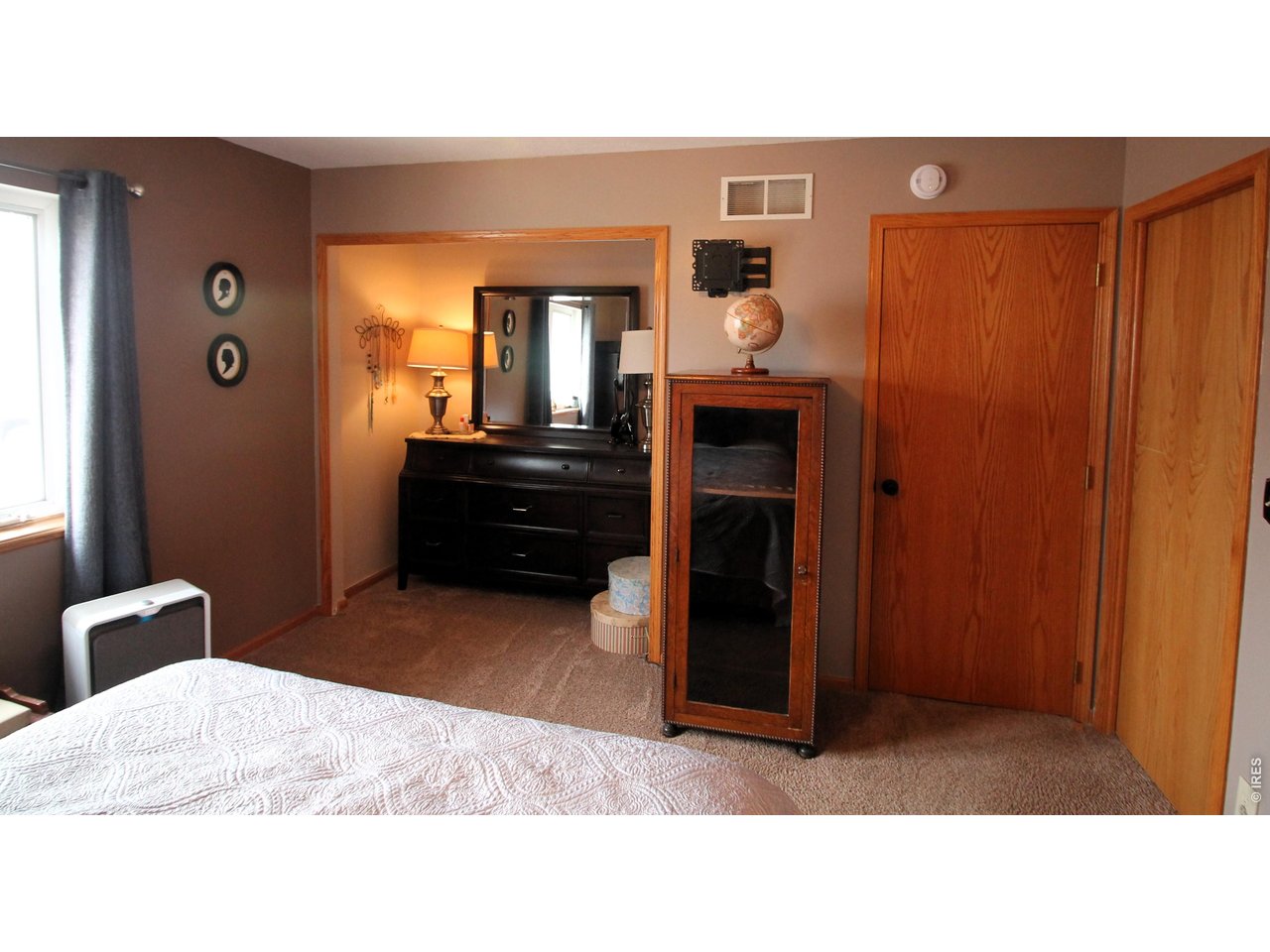 Property Photo 18 Primary bedroom, dresser sits in an extra closet.