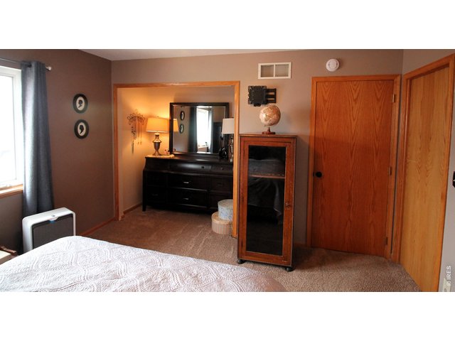 Property Photo 18 Primary bedroom, dresser sits in an extra closet.