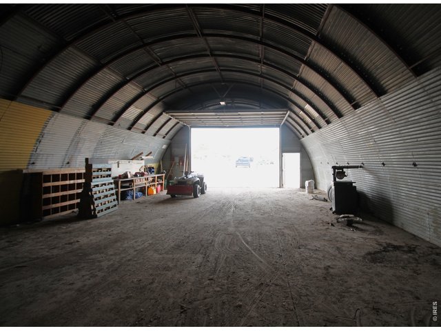 Property Photo 44 Inside Quonset looking west towards overhead door with opener.