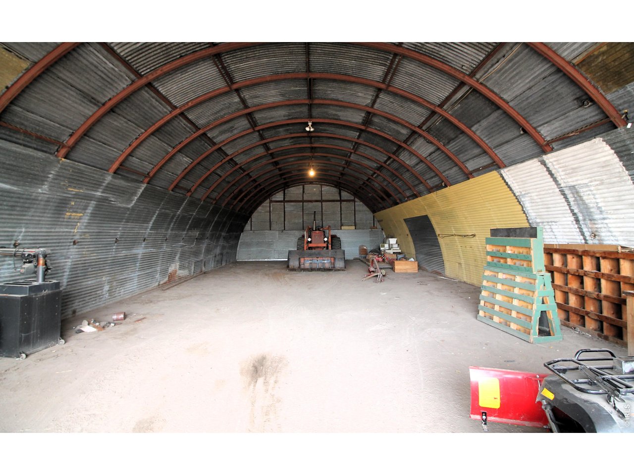 Property Photo 43 Inside of 32x72 Quonset with concrete floor and power. Looking east from door.