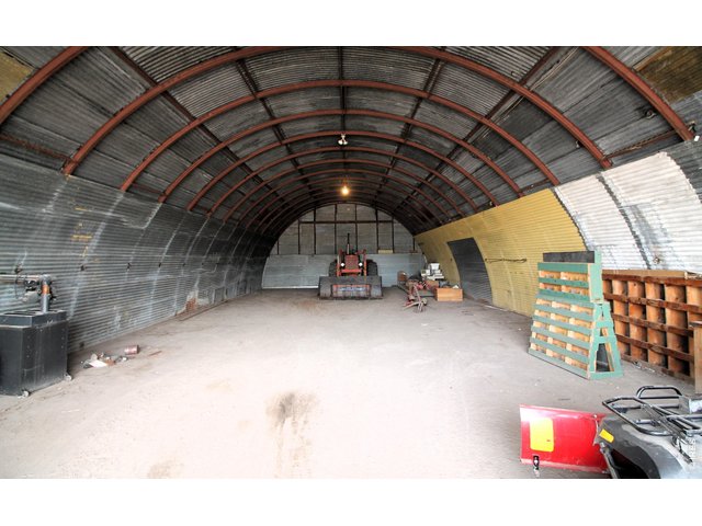 Property Photo 43 Inside of 32x72 Quonset with concrete floor and power. Looking east from door.