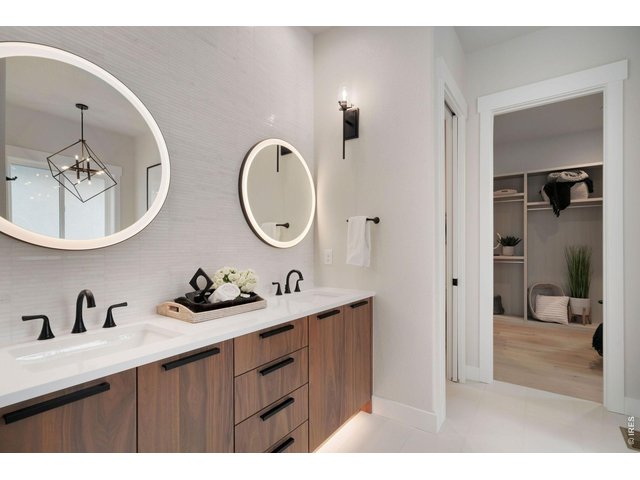 Property Photo 15 Luxury Primary Bath with Dual Sinks and Lighted Mirrors