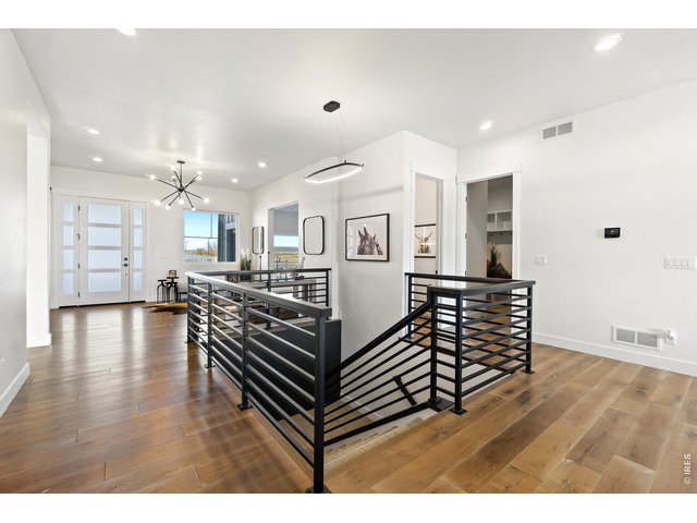 Property Photo 5 Welcoming Entryway with Engineered Hardwood Flooring