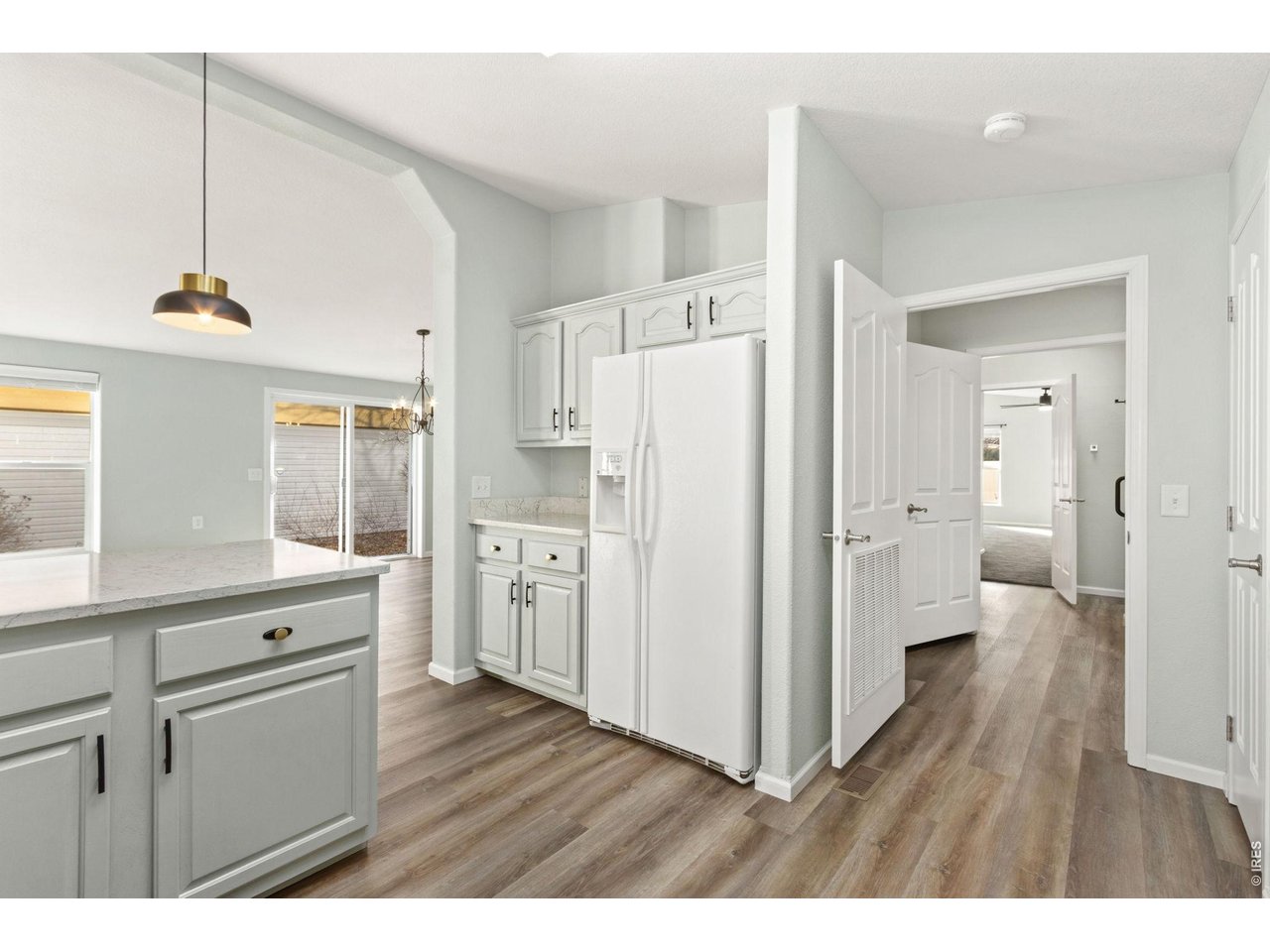 Enter your primary bedroom from the kitchen, or go down the hallway. Looped layout. 