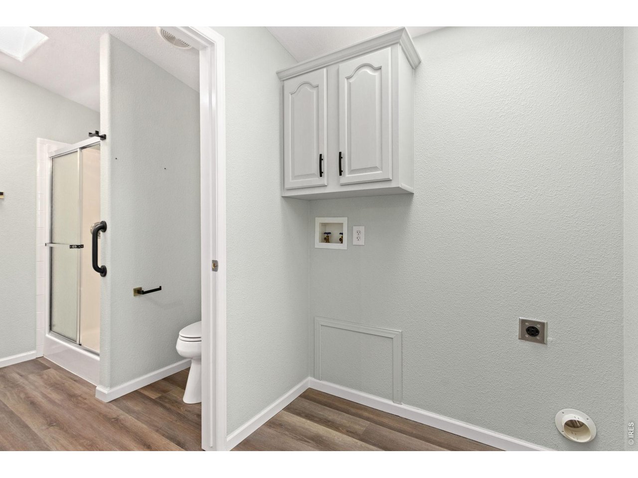 Primary bathroom shower stall. Enter the laundry room and head back into the kitchen from the primary bedroom. 