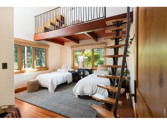 Property Photo 24 Main level guest bedroom featuring Brazilian Cherry (Jatoba) hardwood floor and a forged iron ladder leading to a lofted reading/play space.
