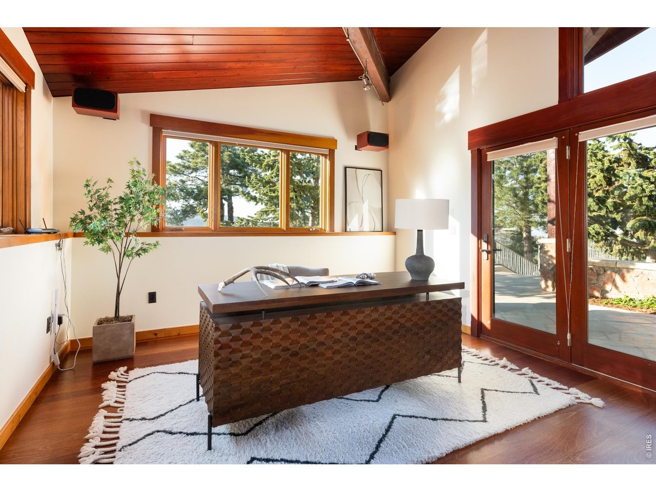 Private, main level study with floor to ceiling windows framing mountain views.