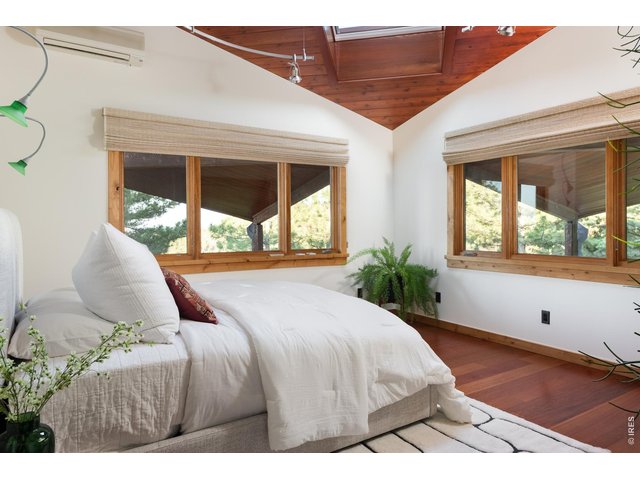 Property Photo 25 Second main level guest bedroom with Brazilian Cherry (Jatoba) hardwood floor and oversized skylight.