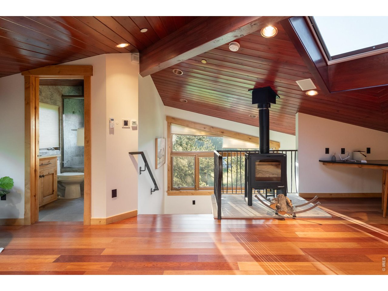 Bedroom loft with cozy wood stove.