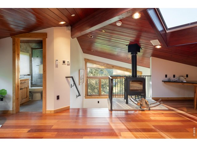 Property Photo 30 Bedroom loft with cozy wood stove.