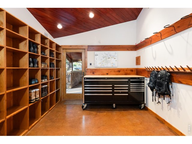 Property Photo 29 Mudroom and bike workshop space with heated floors and stairs leading to guest room. 
