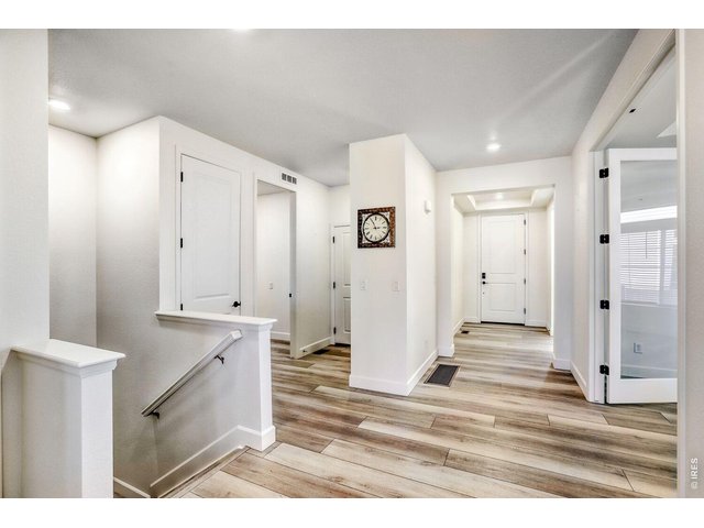 Property Photo 26 Hallway facing Entry Foyer and Steps Leading to Finished Basement