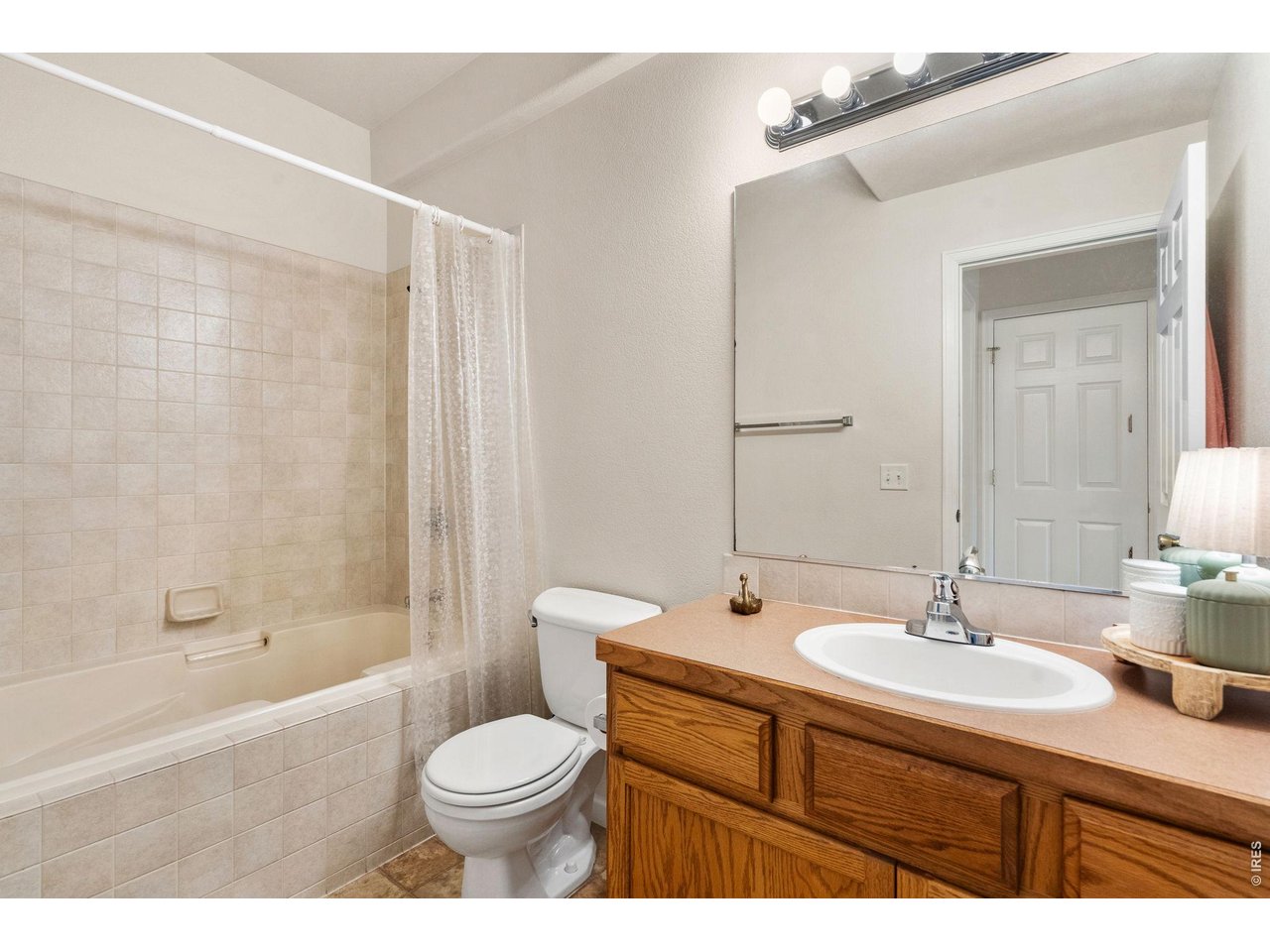Primary bathroom is bright and private with a full tub and shower